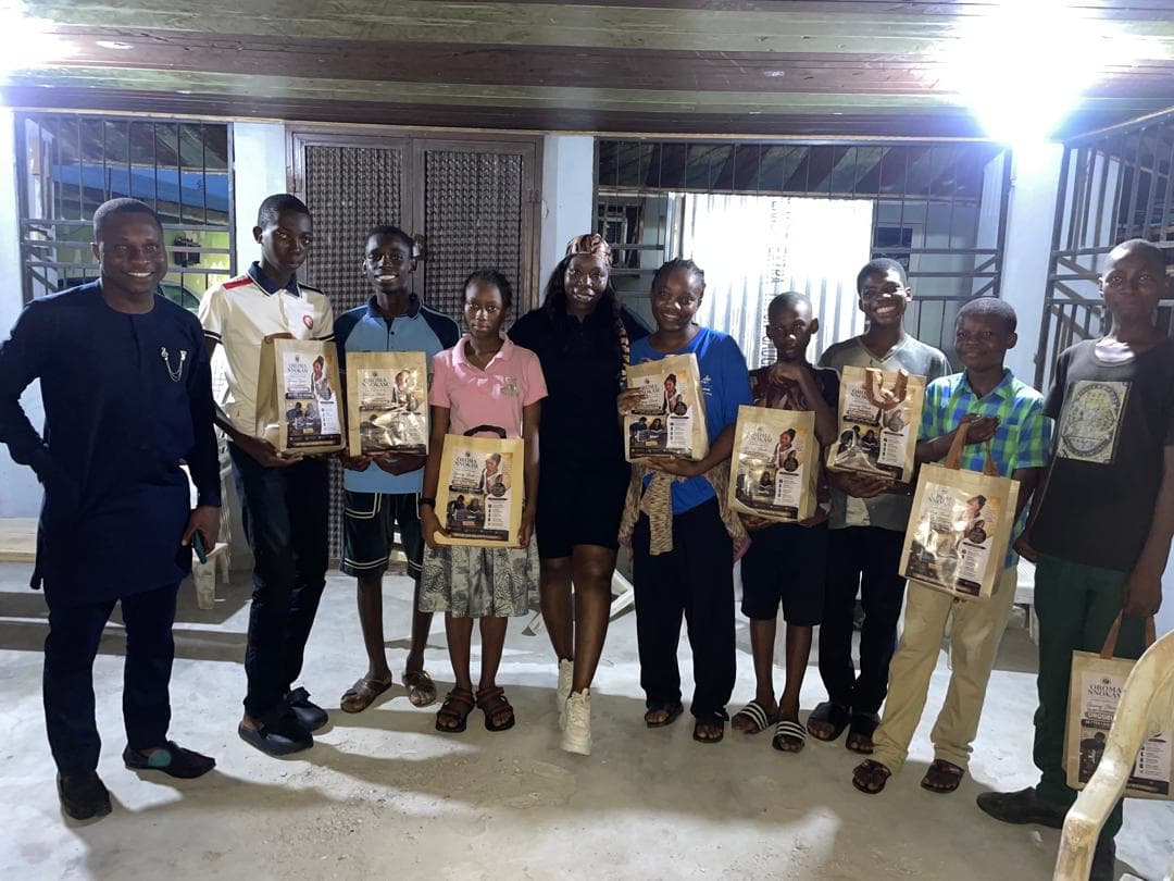 Students of The BLEND Empowerment Foundation holding learning materials after a programme session.